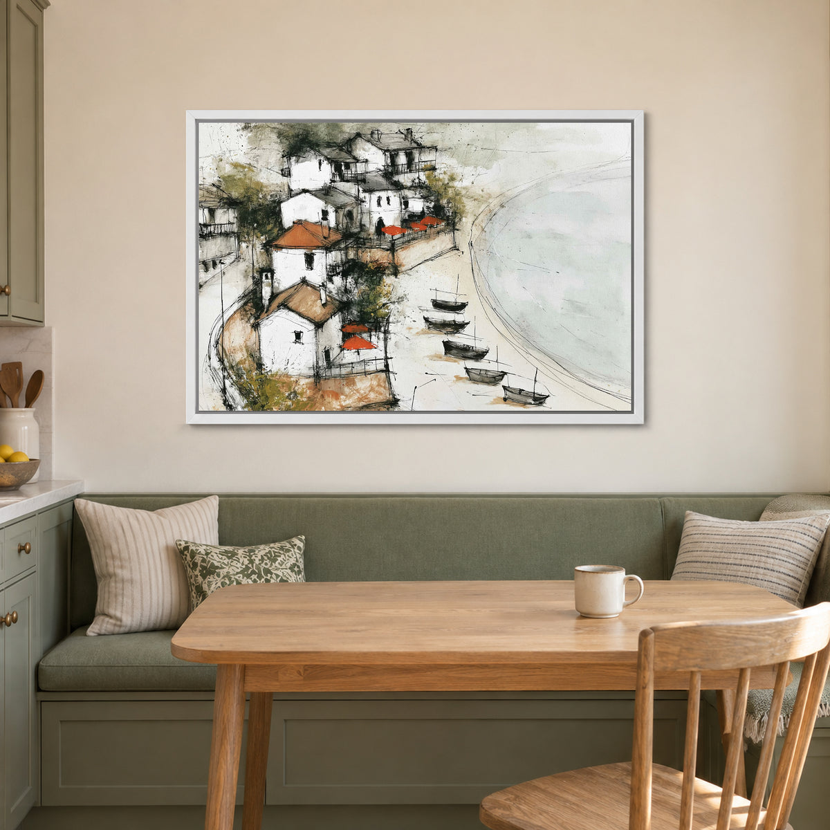 Mediterranean Fishing Boats Coastal framed canvas in a white floating frame above a green banquette and wooden table in a breakfast nook