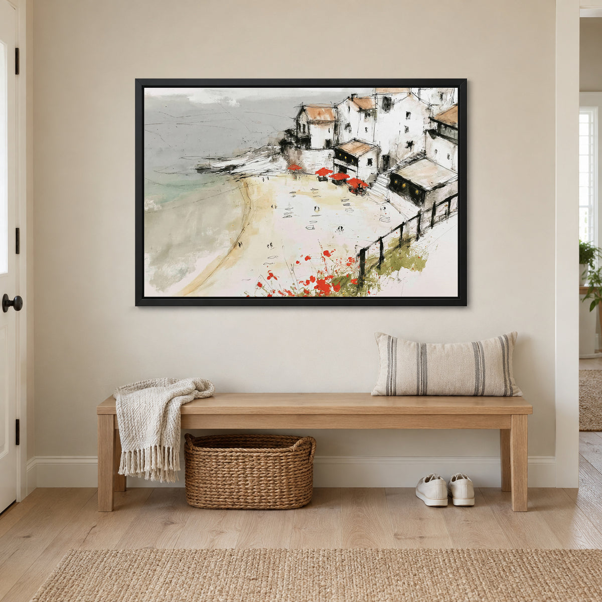 Clifftop Town Red Parasols framed canvas in a black floating frame above a wooden entryway bench with a woven basket