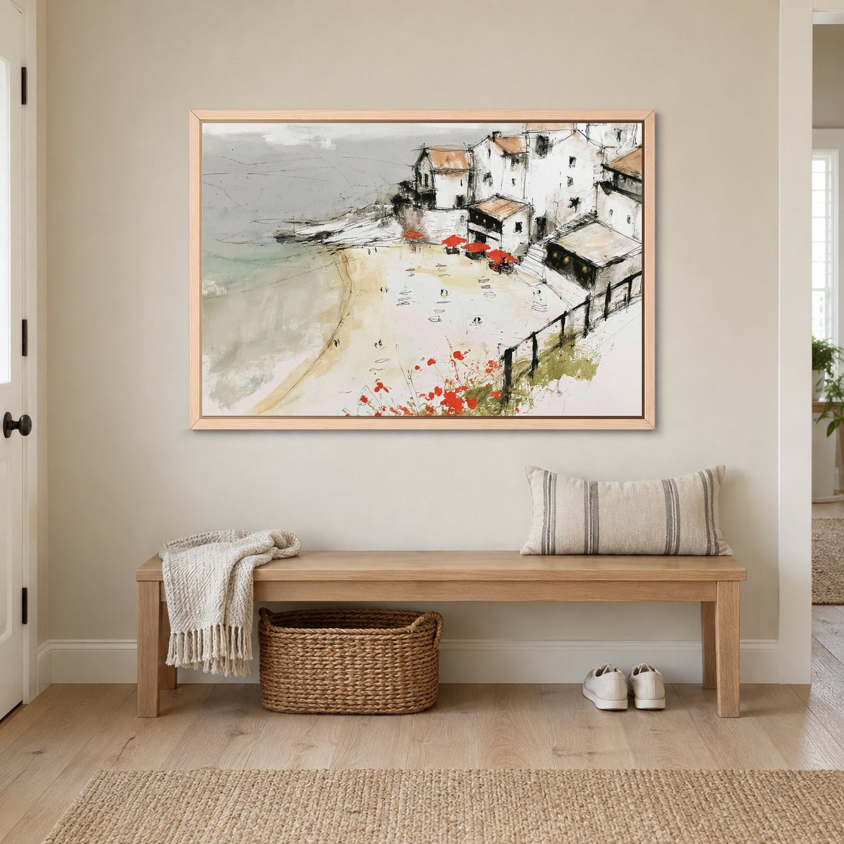 Clifftop Town Red Parasols framed canvas in a natural wood floating frame above a wooden entryway bench with a woven basket