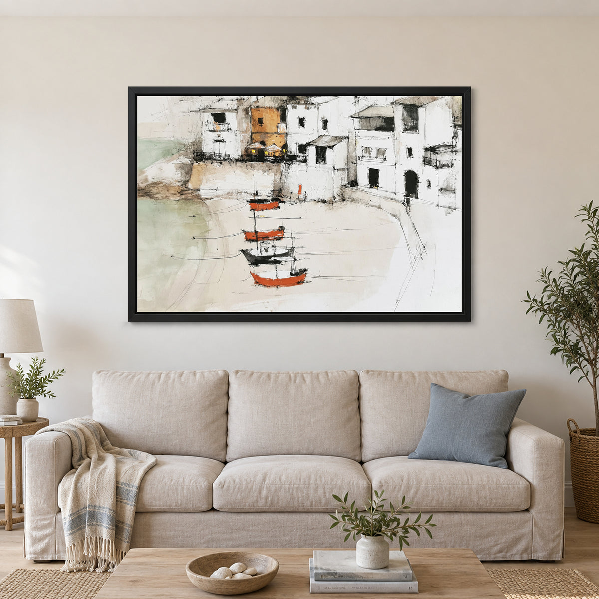 Harbour Houses Beach Boats framed canvas in a black floating frame above a linen sofa with a blue cushion