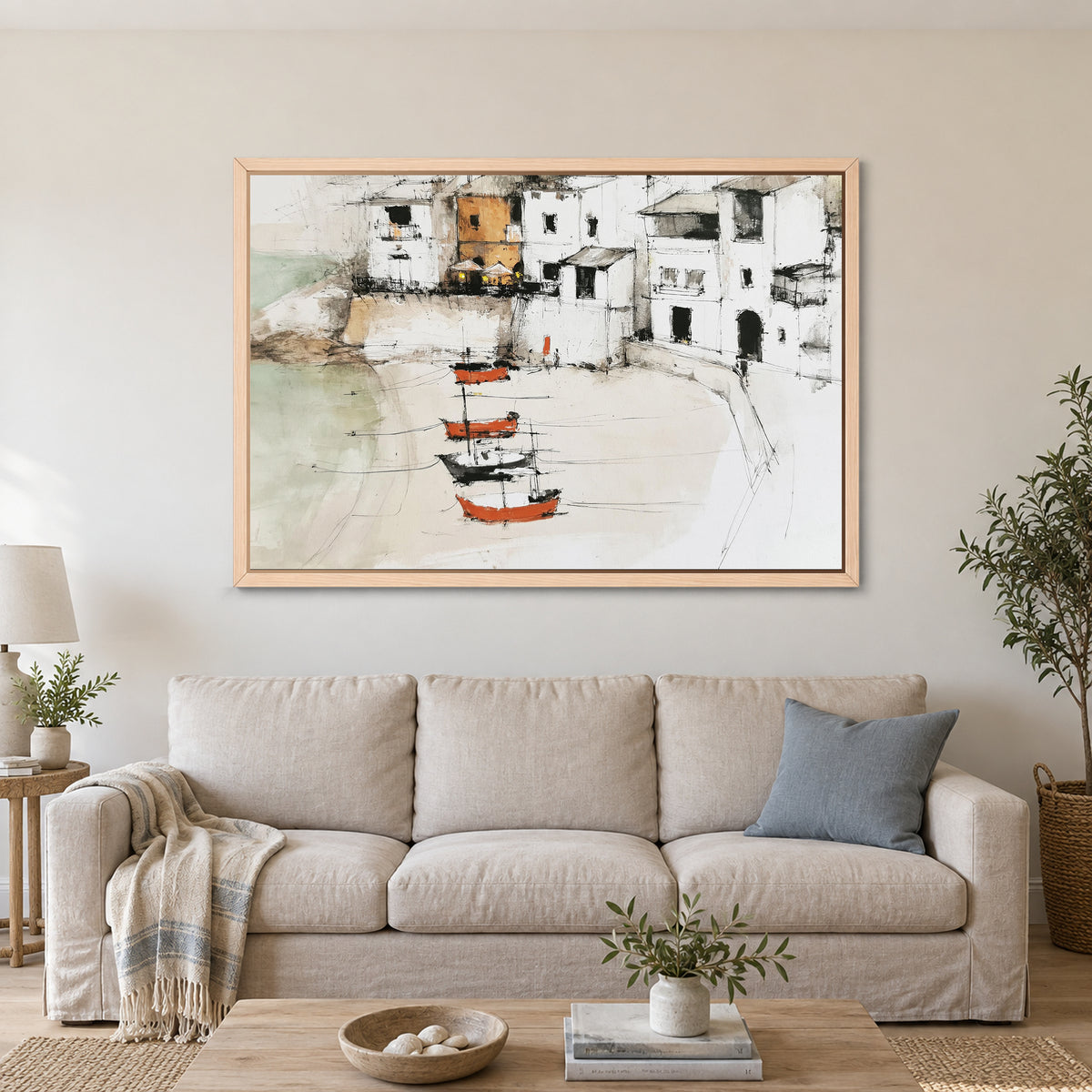 Harbour Houses Beach Boats framed canvas in a natural wood floating frame above a linen sofa with a blue cushion
