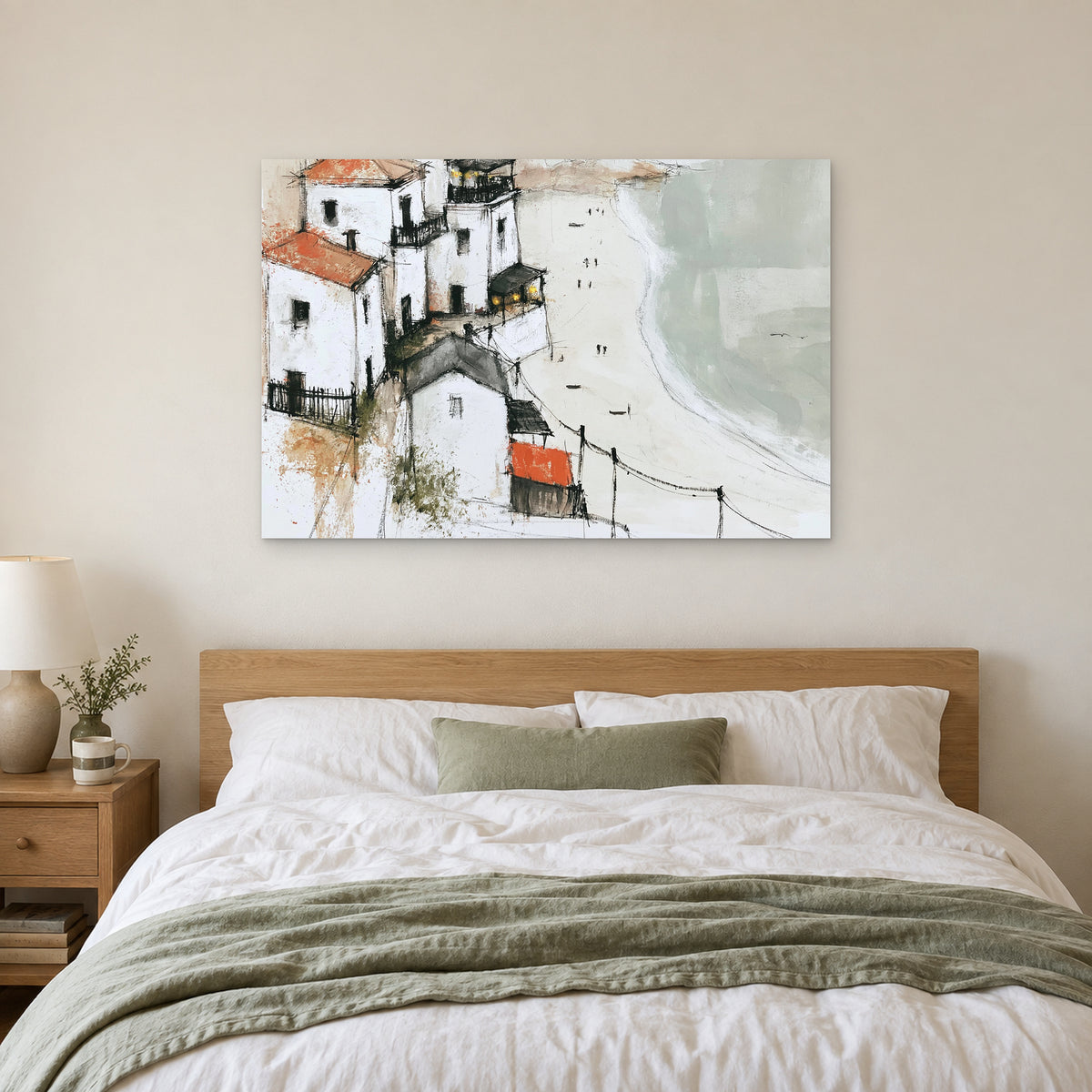 Whitewashed Headland Beach canvas wall art above a bed with white linens and a sage throw