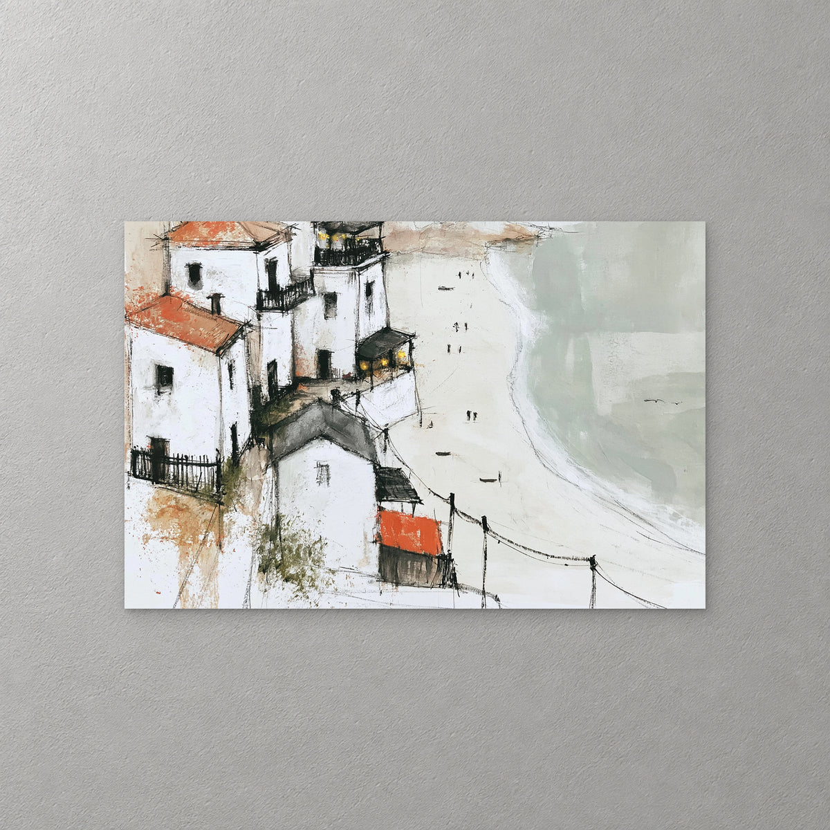 White houses with red roofs stack down a headland above a wide pale beach, a few small figures on the sand and a sage green sea — canvas wall art print