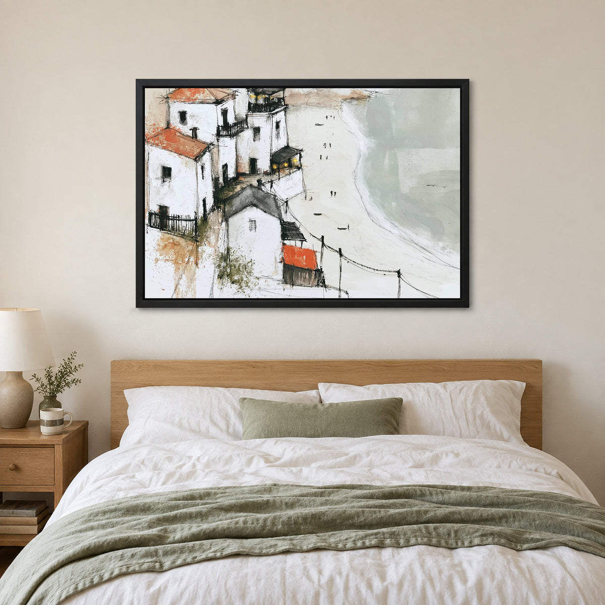Whitewashed Headland Beach framed canvas in a black floating frame above a bed with white linens and a sage throw