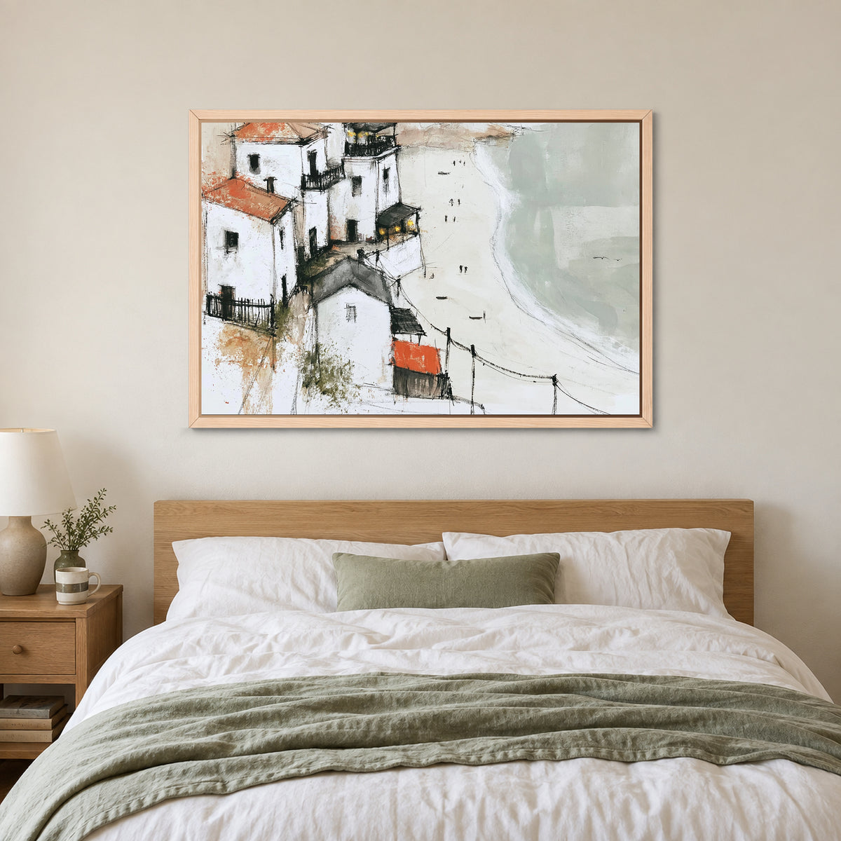 Whitewashed Headland Beach framed canvas in a natural wood floating frame above a bed with white linens and a sage throw