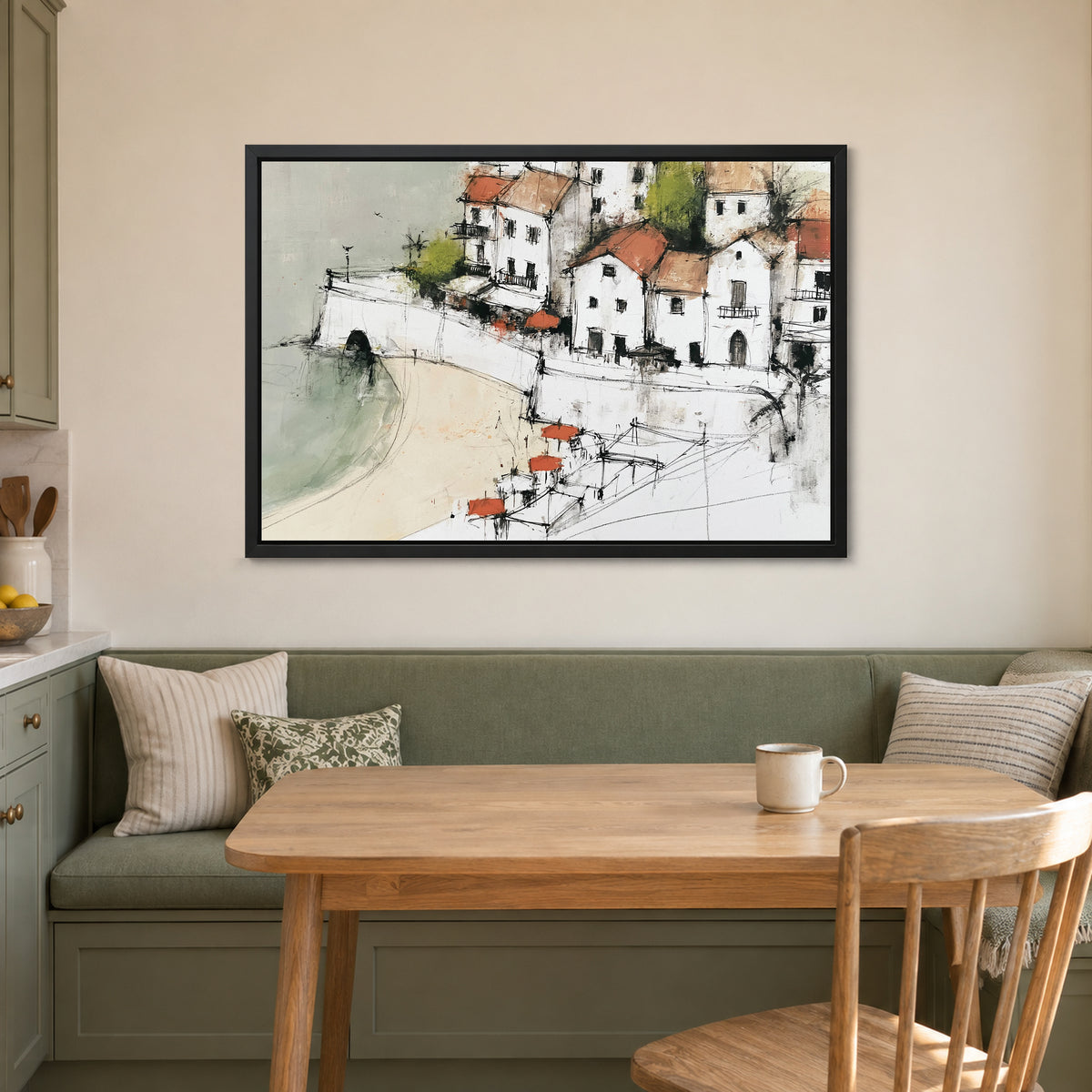 Whitewashed Coastal Town Bay framed canvas in a black floating frame above a green banquette and wooden table in a breakfast nook