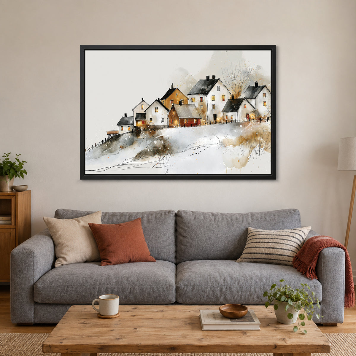 Reine Norway Winter Harbour framed canvas in a black floating frame above a grey sofa with rust and striped cushions