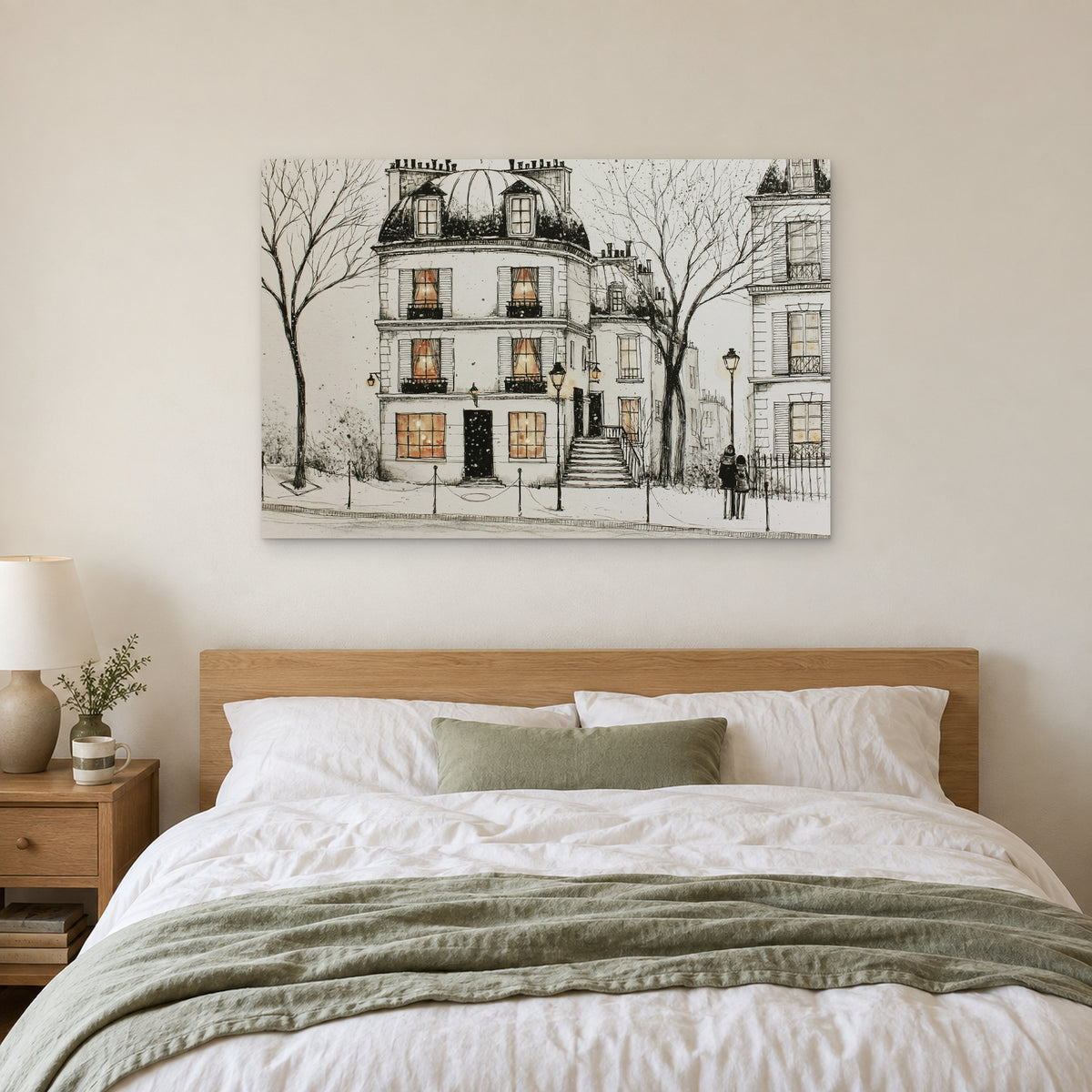 Paris Townhouse Snow canvas wall art above a bed with white linens and a sage throw