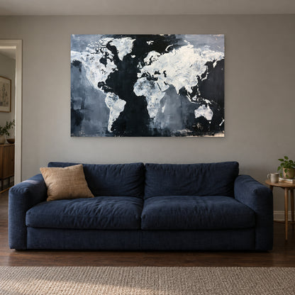 World Map Black and White canvas wall art above a navy sofa in a living room
