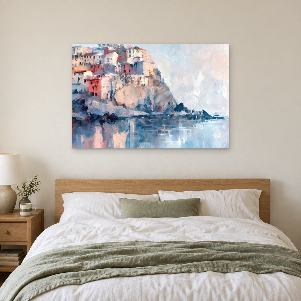Cinque Terre Cliff Houses Coastal canvas wall art above a bed with white linens and a sage throw