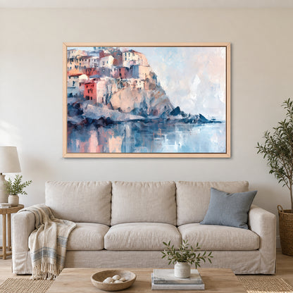 Cinque Terre Cliff Houses Coastal framed canvas in a natural wood floating frame above a linen sofa with a blue cushion