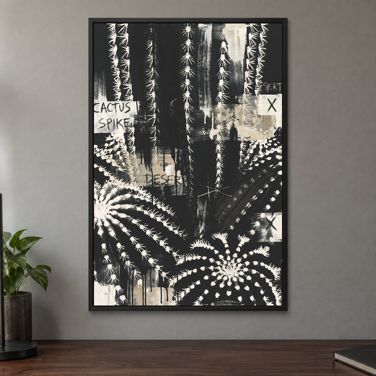 Black and White Cactus Desert framed canvas in a black floating frame on a taupe wall above a dark walnut sideboard with a potted plant