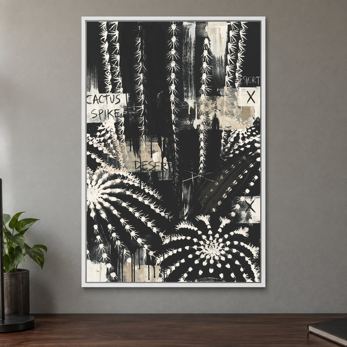 Black and White Cactus Desert framed canvas in a white floating frame on a taupe wall above a dark walnut sideboard with a potted plant