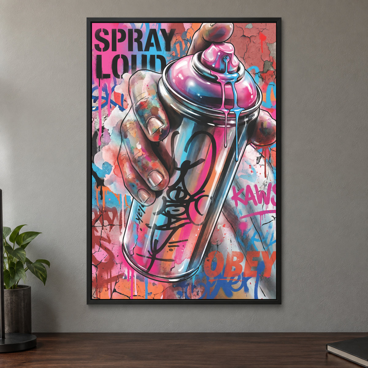 Spray Can Graffiti Street Art framed canvas in a black floating frame on a taupe wall above a dark walnut sideboard with a potted plant