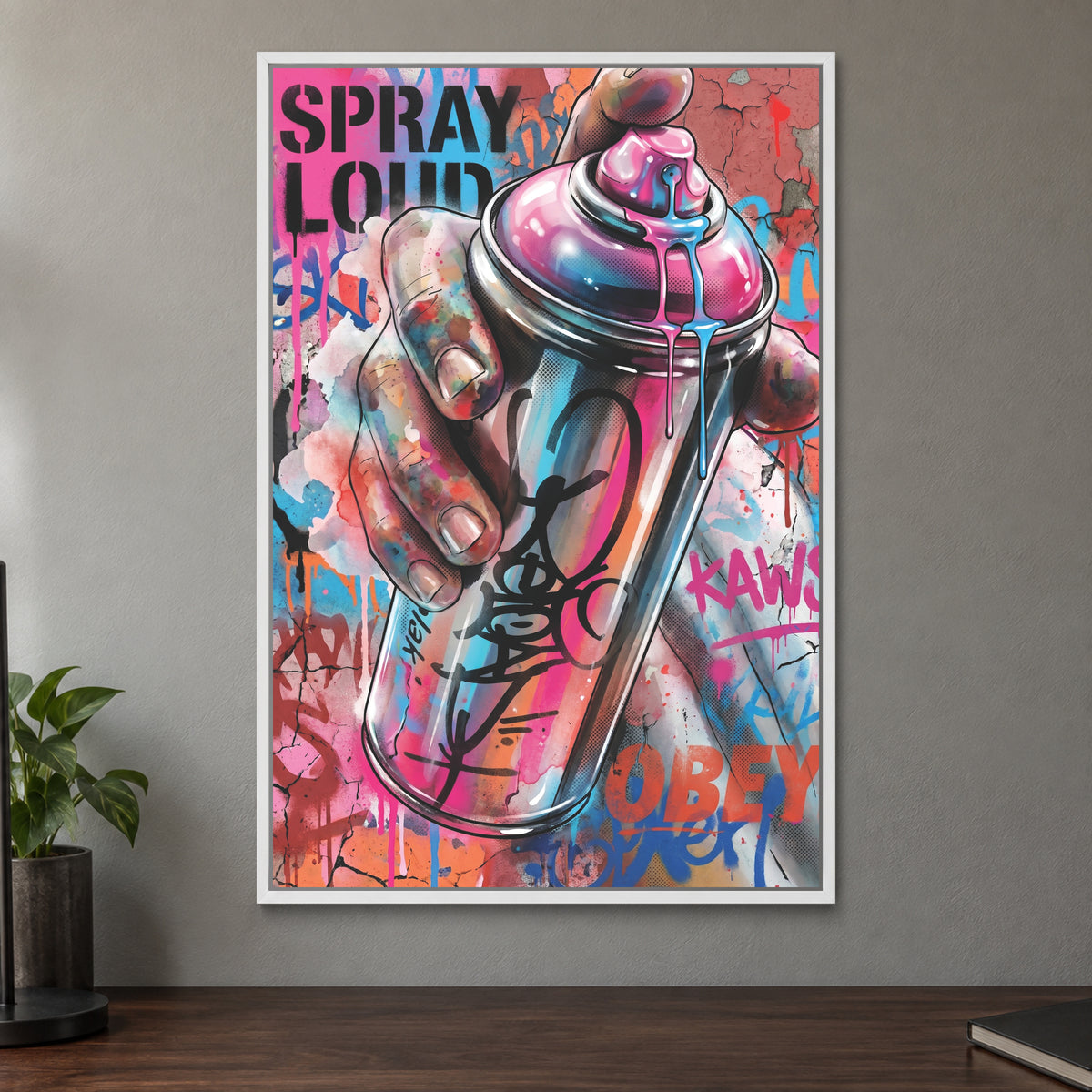 Spray Can Graffiti Street Art framed canvas in a white floating frame on a taupe wall above a dark walnut sideboard with a potted plant