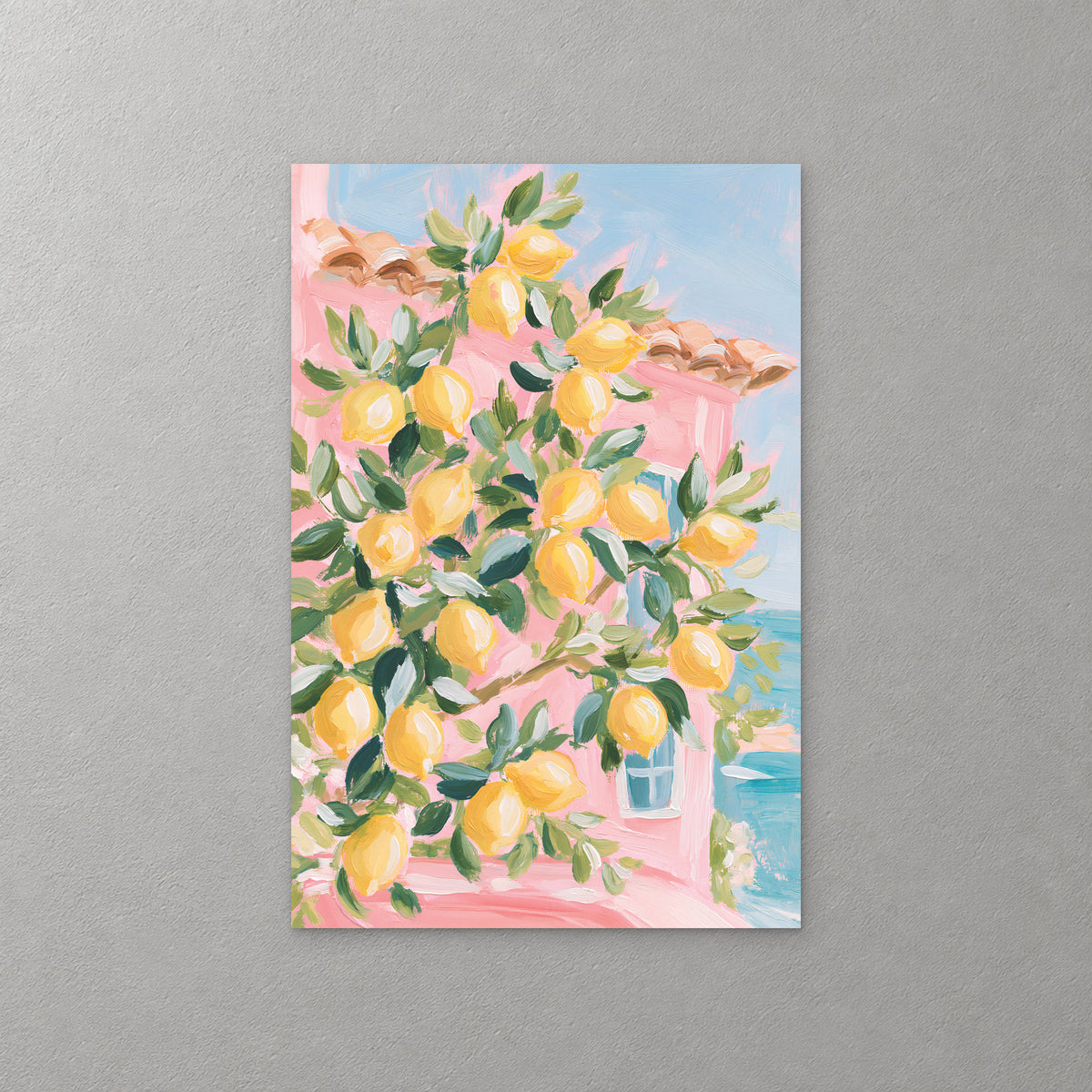 A lemon tree heavy with yellow fruit fills the frame in front of a pink house with a blue shutter, with a glimpse of turquoise sea at the right — canvas wall art print