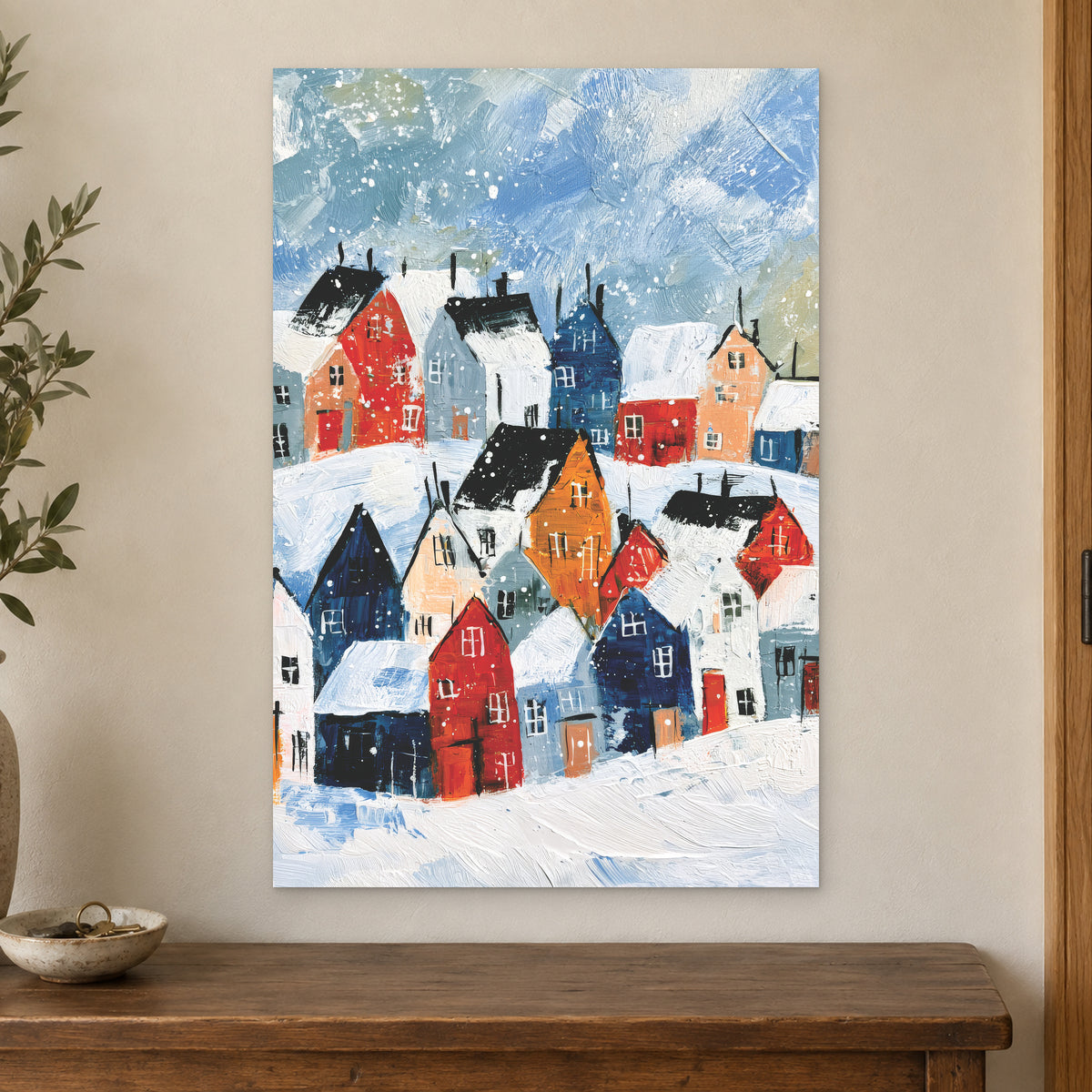 Snowfall Over the Rooftops canvas wall art on a cream wall above a wooden sideboard beside a door frame