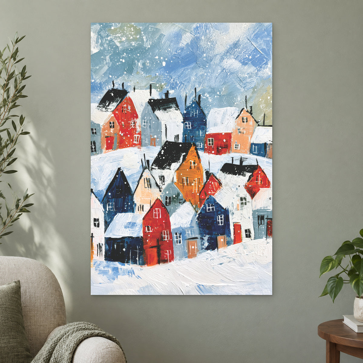 Snowfall Over the Rooftops canvas wall art on a sage green wall beside a cream armchair
