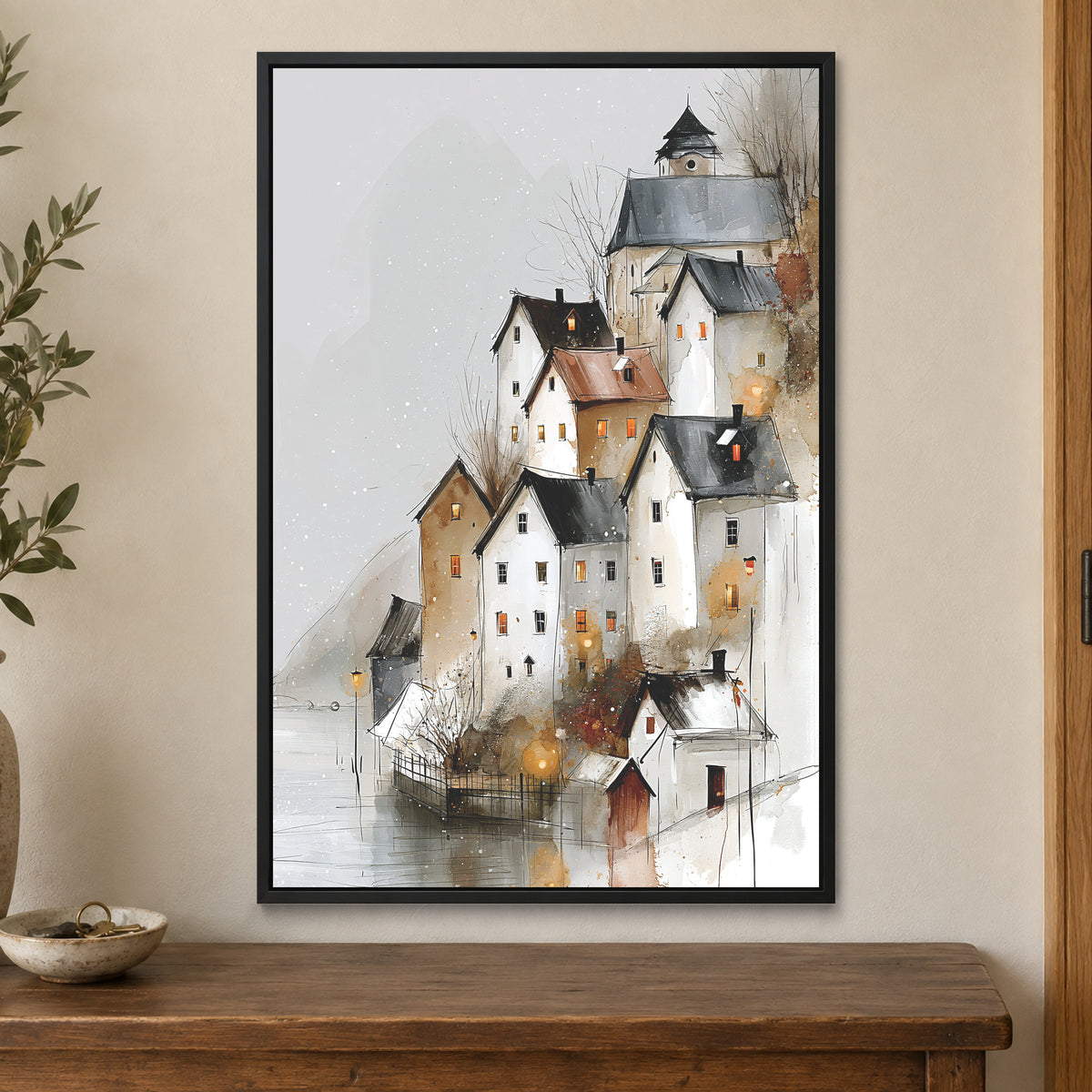 Hallstatt Austria Winter Rooftops framed canvas in a black floating frame on a cream wall above a wooden sideboard beside a door frame