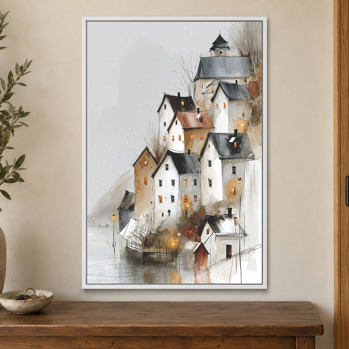 Hallstatt Austria Winter Rooftops framed canvas in a white floating frame on a cream wall above a wooden sideboard beside a door frame