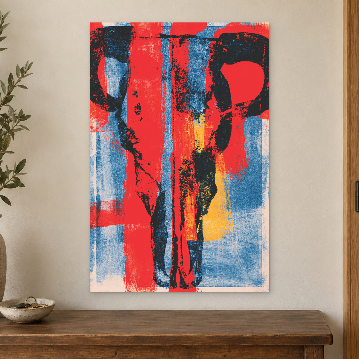 Bull Skull Bold Screenprint canvas wall art on a cream wall above a wooden sideboard beside a door frame