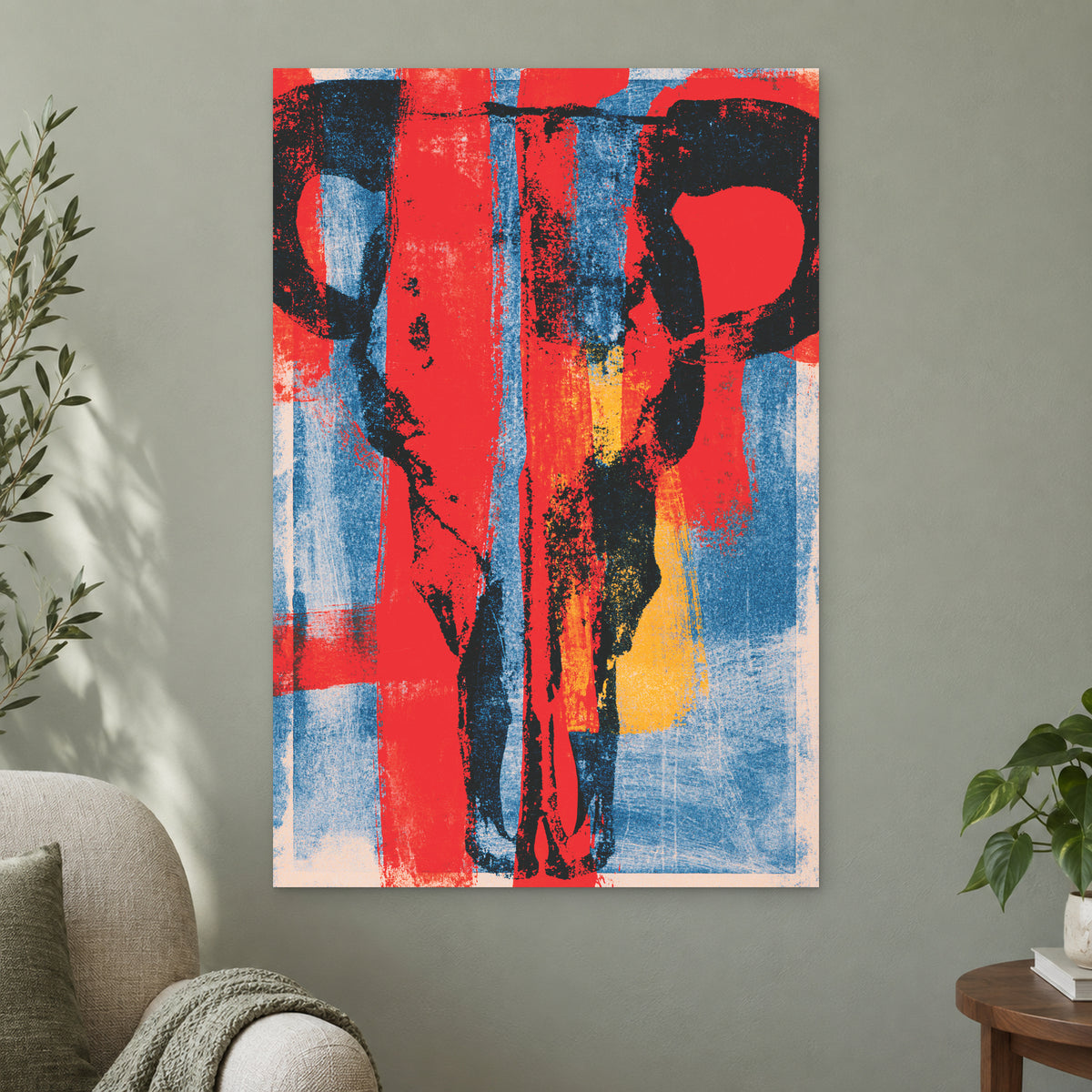 Bull Skull Bold Screenprint canvas wall art on a sage green wall beside a cream armchair