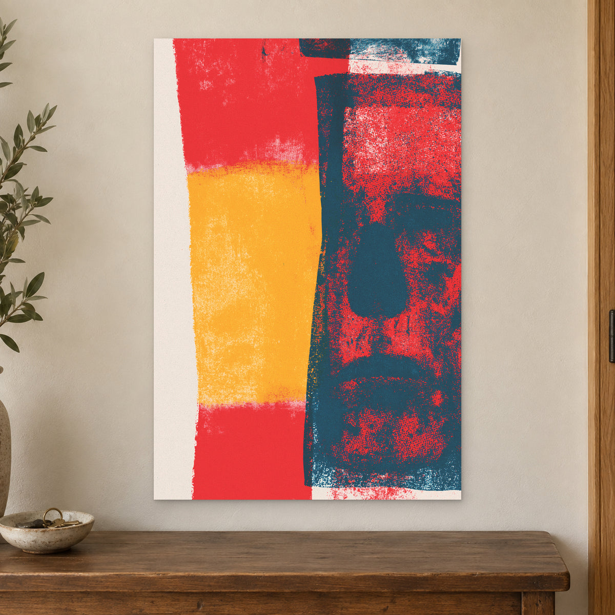 Almost a Face Abstract canvas wall art on a cream wall above a wooden sideboard beside a door frame