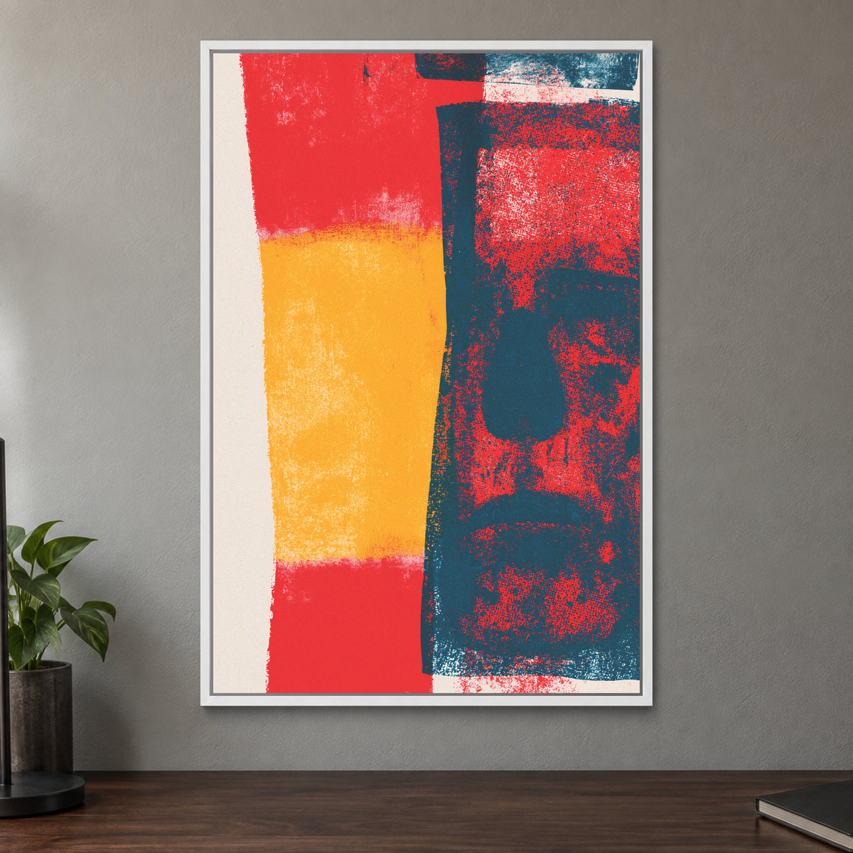 Almost a Face Abstract framed canvas in a white floating frame on a taupe wall above a dark walnut sideboard with a potted plant