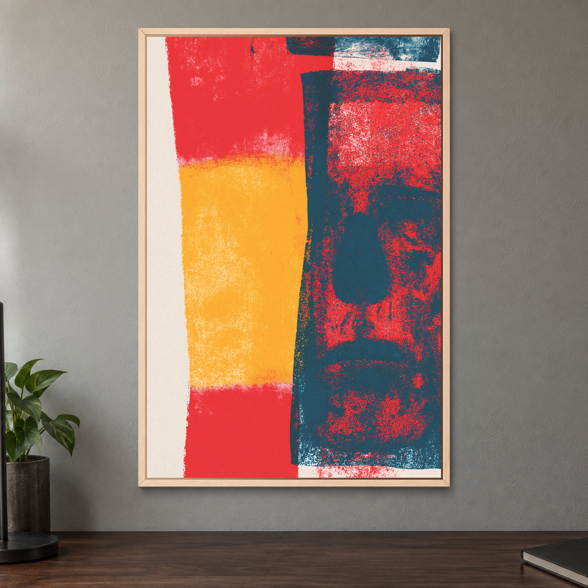 Almost a Face Abstract framed canvas in a natural wood floating frame on a taupe wall above a dark walnut sideboard with a potted plant