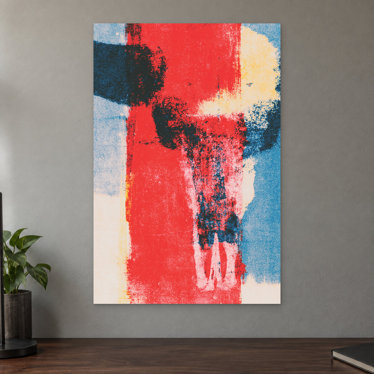 Red Field Skull Abstract canvas wall art on a taupe wall above a dark walnut sideboard with a potted plant