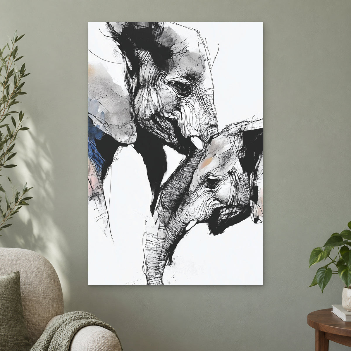 Elephant and Calf Nose to Nose canvas wall art on a sage green wall beside a cream armchair