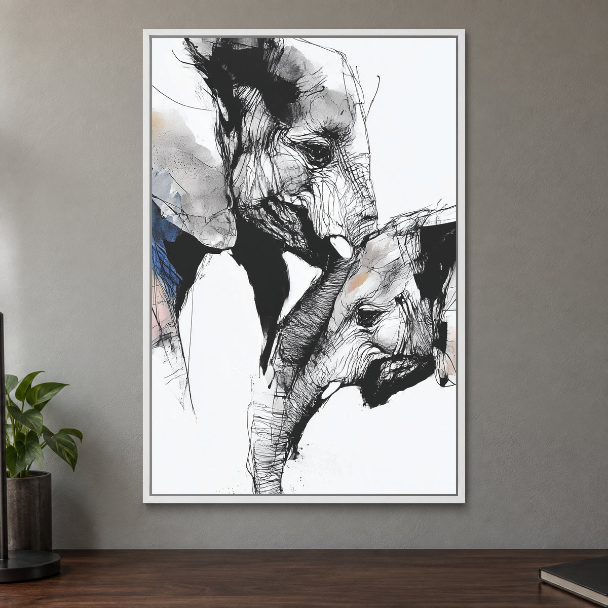Elephant and Calf Nose to Nose framed canvas in a white floating frame on a taupe wall above a dark walnut sideboard with a potted plant