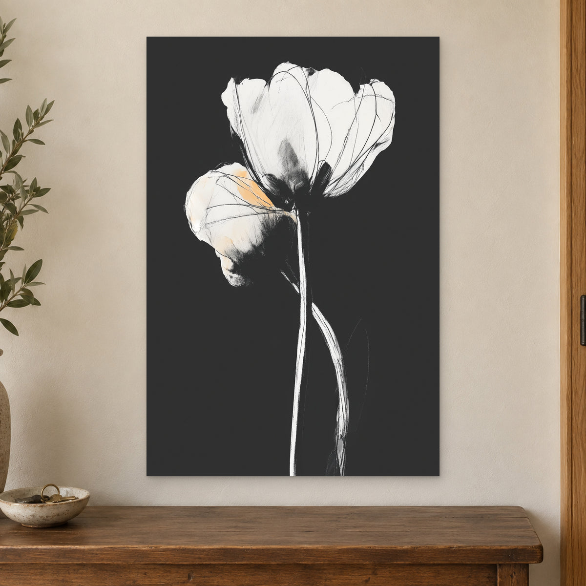 White Tulips on Black canvas wall art on a cream wall above a wooden sideboard beside a door frame