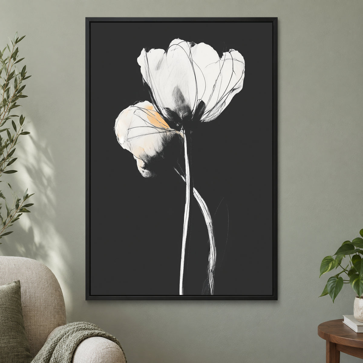 White Tulips on Black framed canvas in a black floating frame on a sage green wall beside a cream armchair