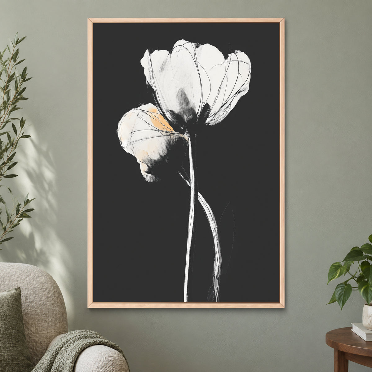 White Tulips on Black framed canvas in a natural wood floating frame on a sage green wall beside a cream armchair