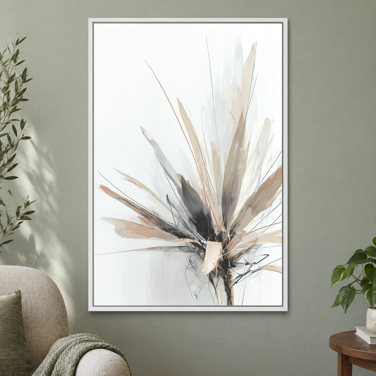 Botanical Sunburst framed canvas in a white floating frame on a sage green wall beside a cream armchair