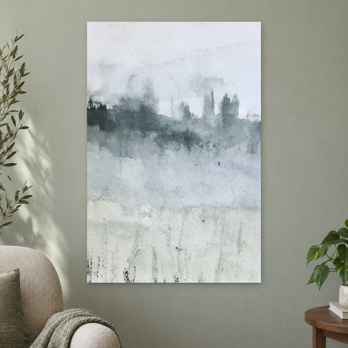 Misty Treeline Minimalist canvas wall art on a sage green wall beside a cream armchair