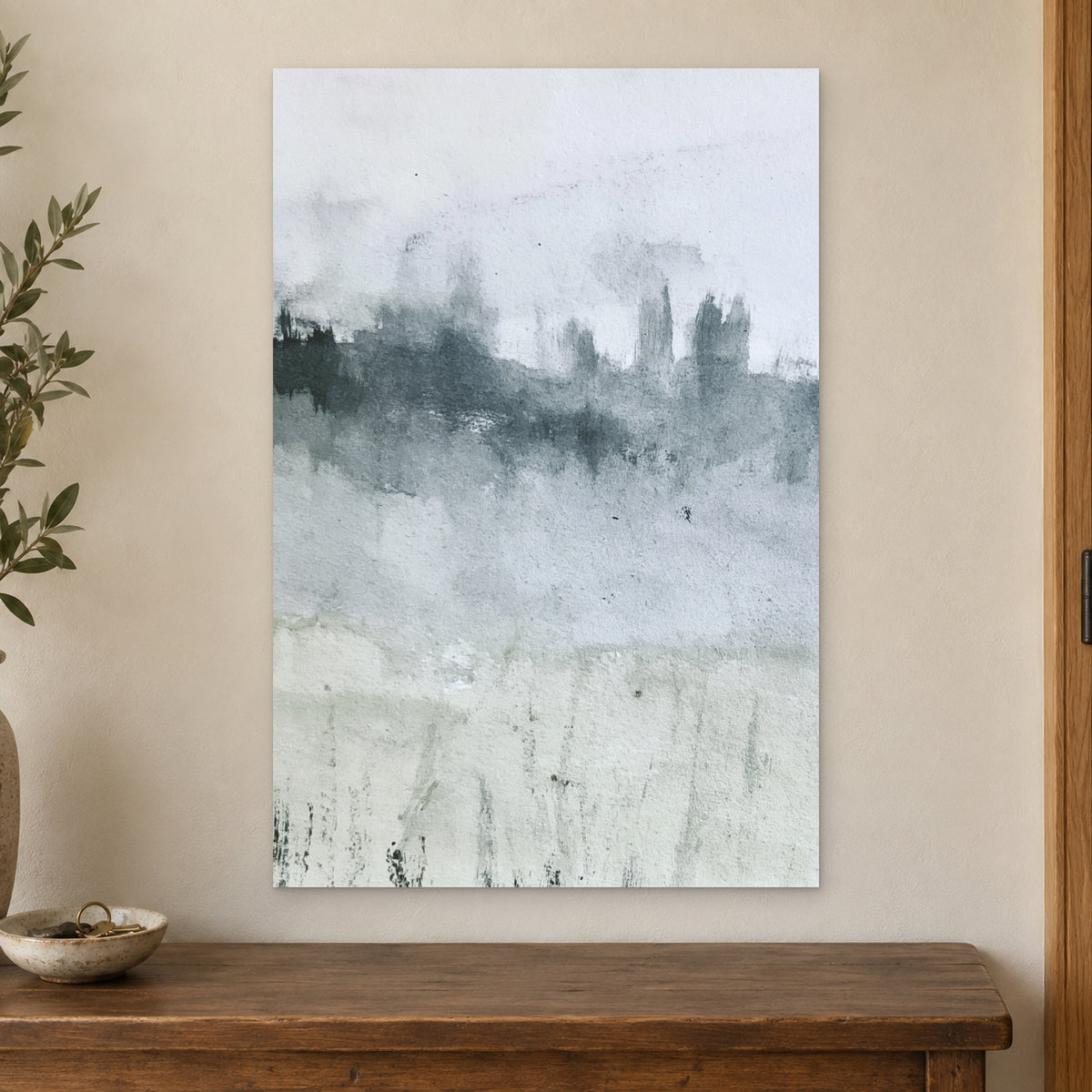 Misty Treeline Minimalist canvas wall art on a cream wall above a wooden sideboard beside a door frame