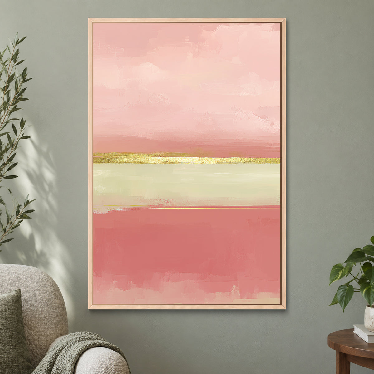 Blush Bands and a Gold Seam framed canvas in a natural wood floating frame on a sage green wall beside a cream armchair