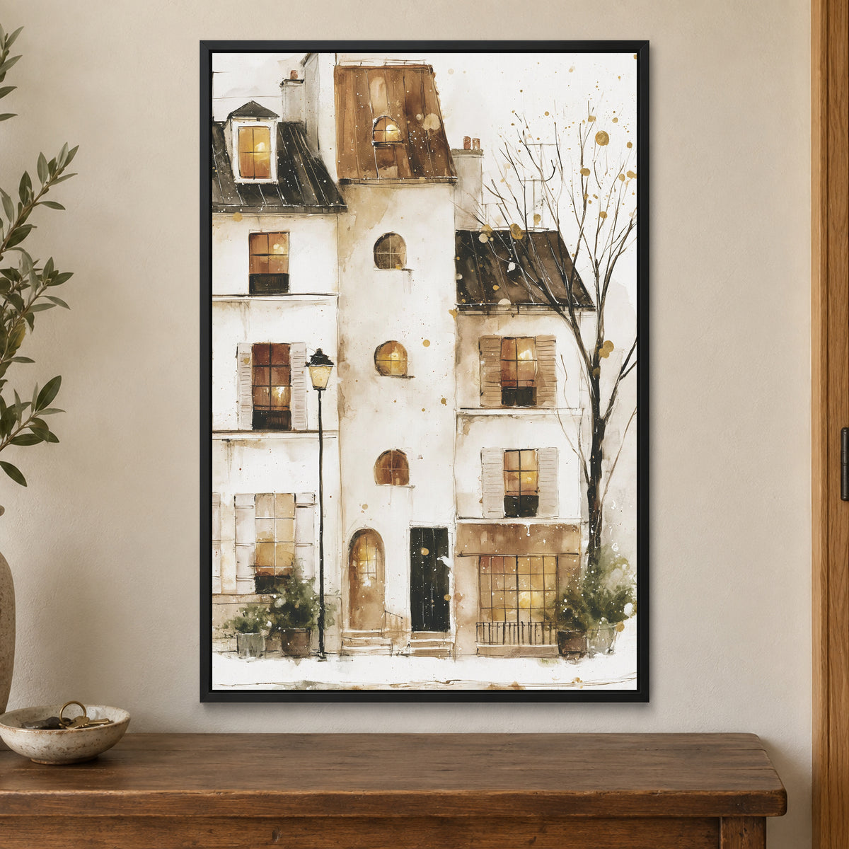 Snowy Paris Windows Watercolour framed canvas in a black floating frame on a cream wall above a wooden sideboard beside a door frame
