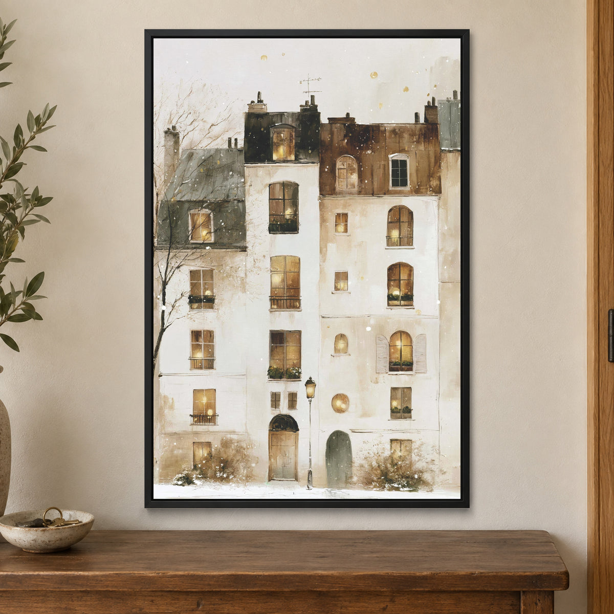 Snowfall in Paris Watercolour framed canvas in a black floating frame on a cream wall above a wooden sideboard beside a door frame