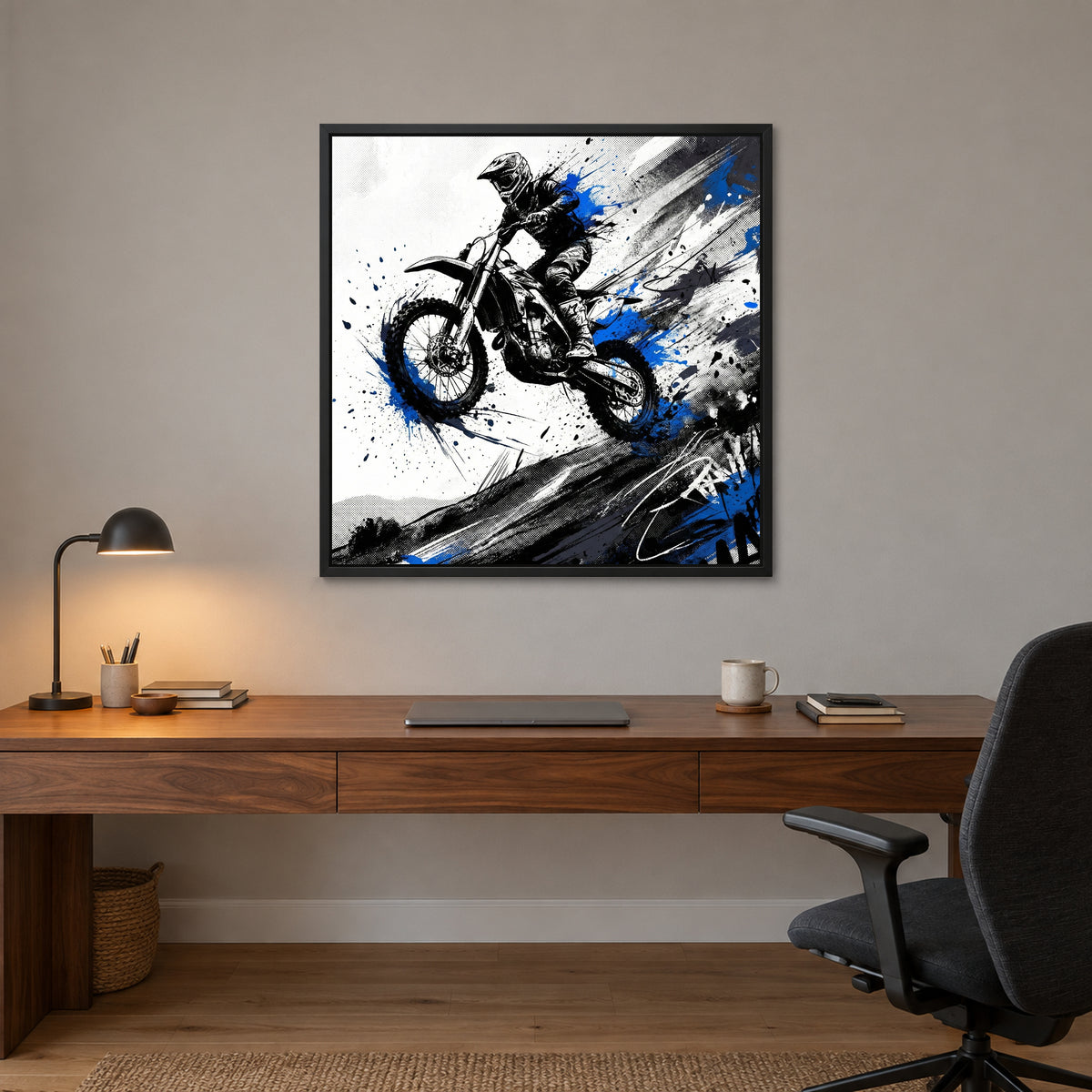 Motocross Airborne Ink framed canvas in a black floating frame above a walnut desk with a brass lamp in a home office