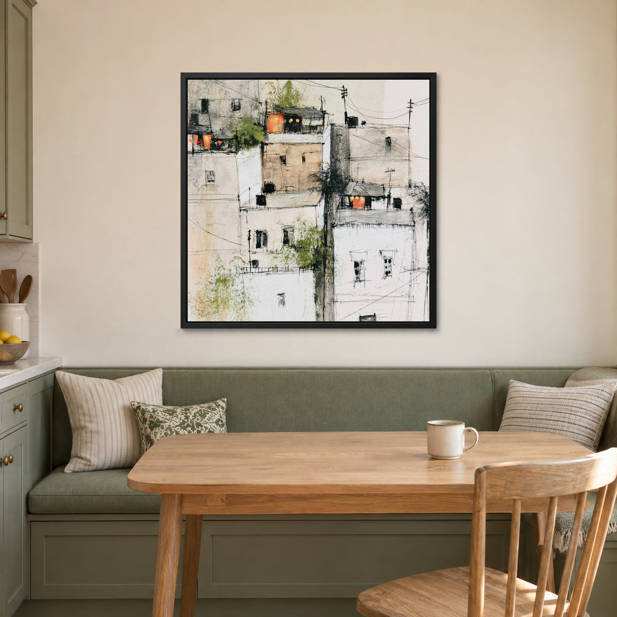 Wires Over a Hill Town framed canvas in a black floating frame above a green banquette and wooden table in a breakfast nook