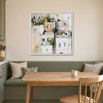 Wires Over a Hill Town framed canvas in a white floating frame above a green banquette and wooden table in a breakfast nook