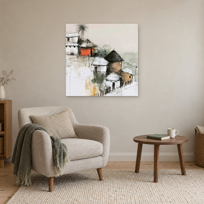 One Red Hut on the Slope canvas wall art above a cream armchair and round wooden side table