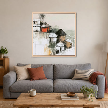 One Red Hut on the Slope framed canvas in a natural wood floating frame above a grey sofa with rust and striped cushions