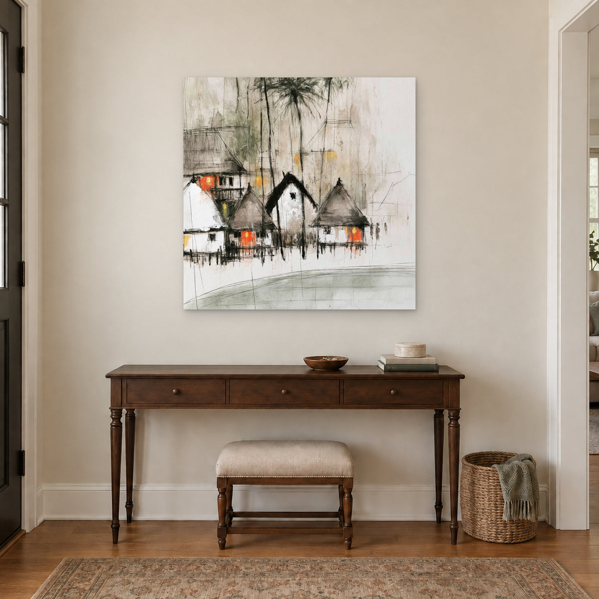 Stilt Huts and Running Ink canvas wall art above a dark wood console table and upholstered bench in an entryway