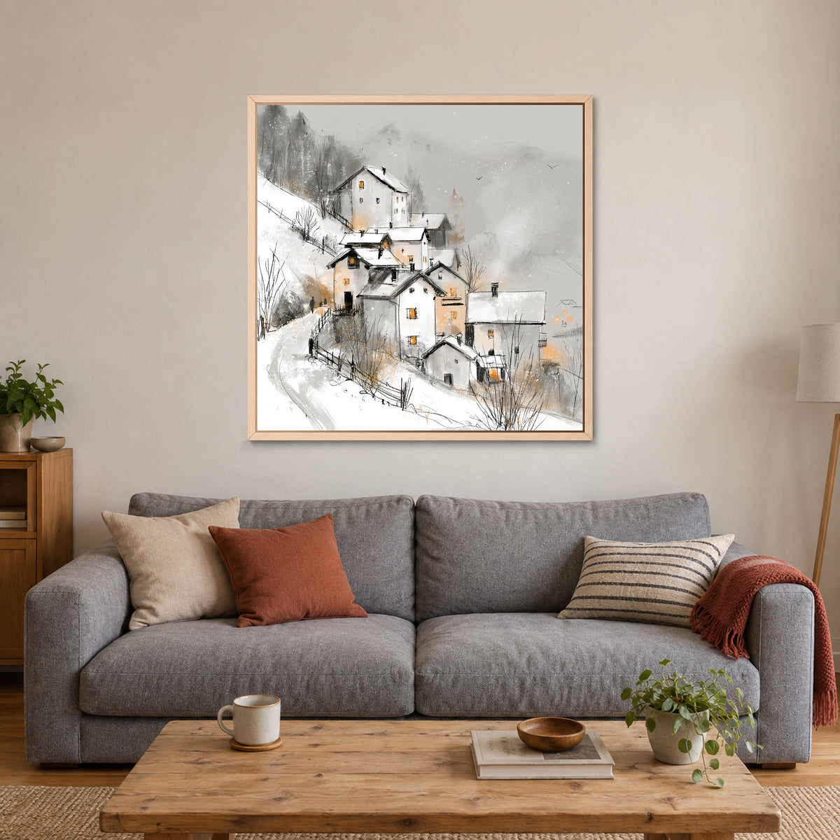 Dolomites Road and Lake framed canvas in a natural wood floating frame above a grey sofa with rust and striped cushions