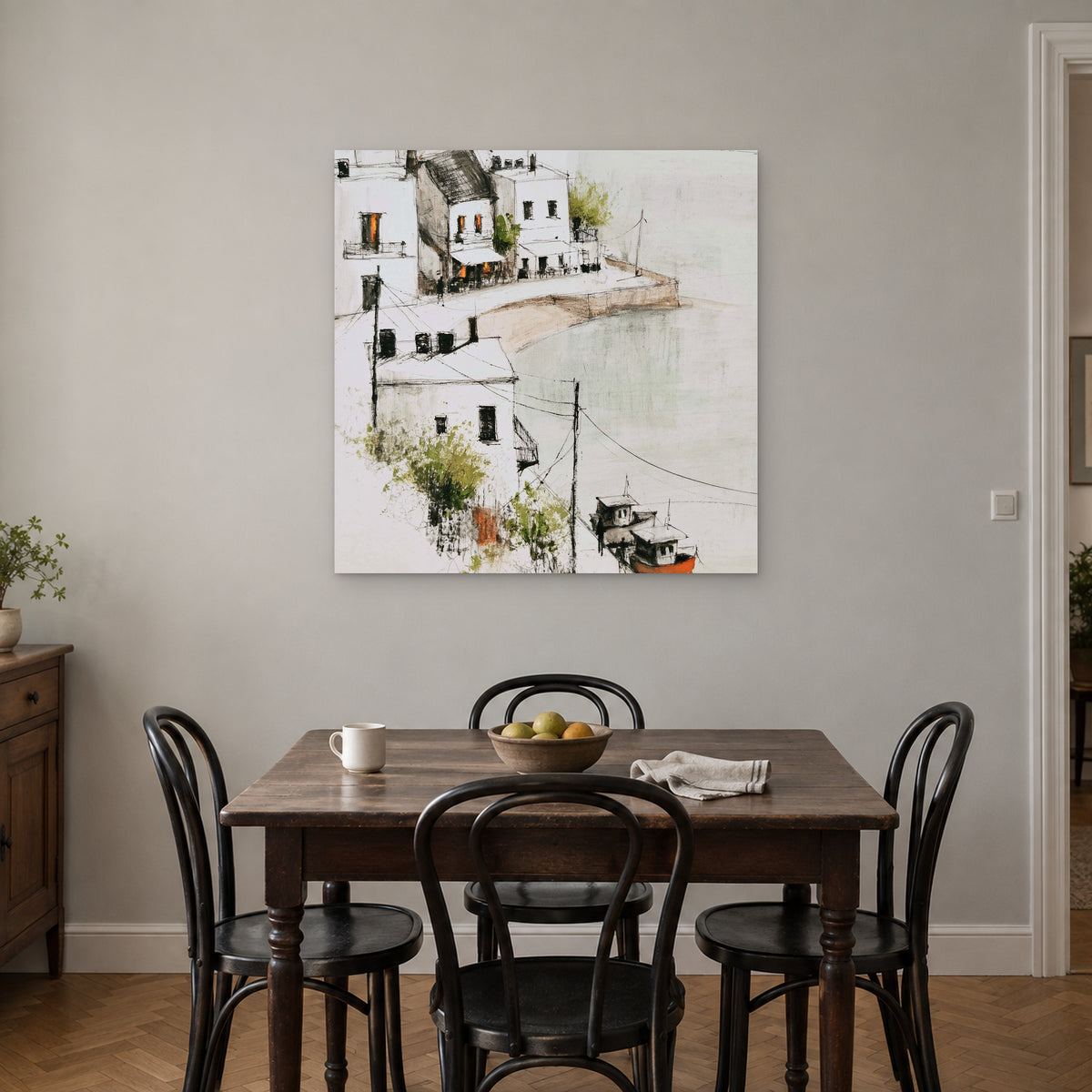 Harbour Cafe Two Boats canvas wall art above a small wooden dining table with black bentwood chairs