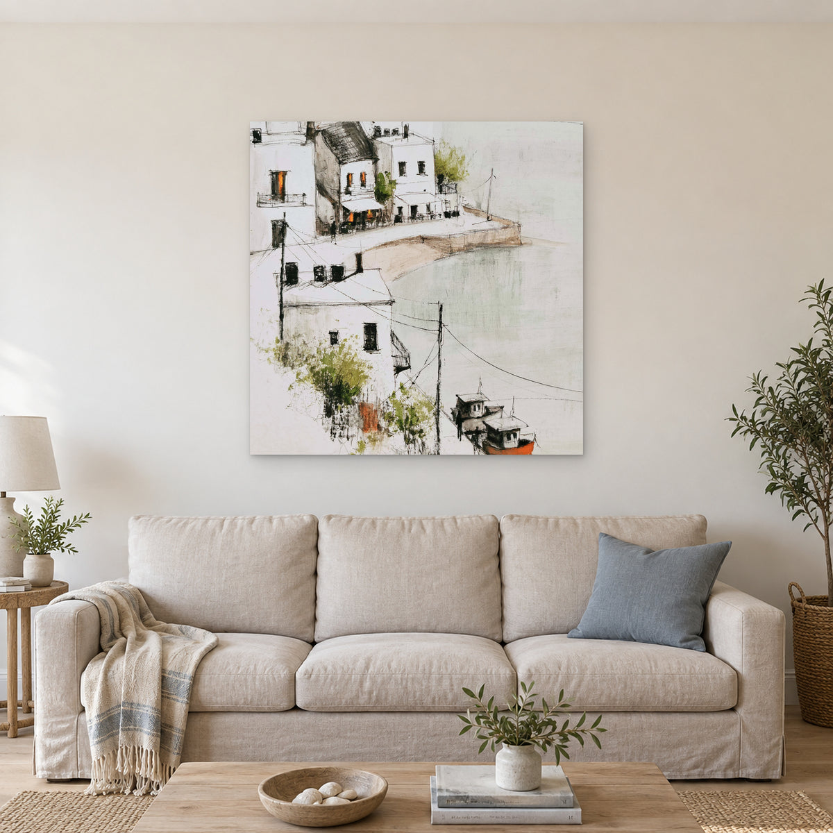 Harbour Cafe Two Boats canvas wall art above a linen sofa with a blue cushion in a bright living room